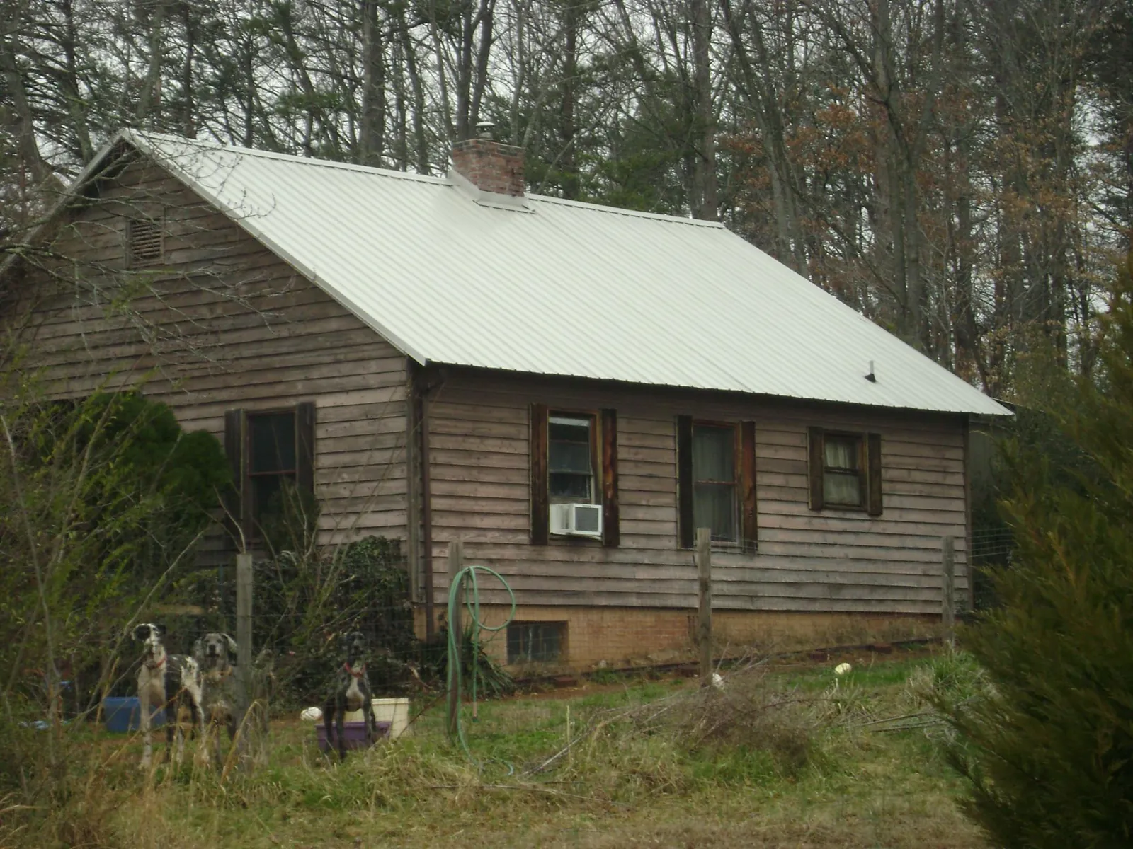 White metal roof on an old wood sided farmhouse, from a Metal Roof Installation job in Whitehall